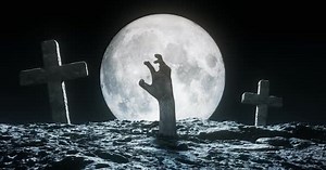 Spooky Zombie Hand Rises from Grave Under Full Moon