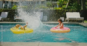 Happy diverse young family playing and jumping in the pool on summer vacation, family kids lifestyle, cinematic slow motion