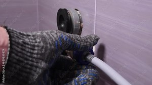 Plumber removing the hose from the washing machine. Disconnecting the washing machine or dishwasher from the water supply. Stock Video