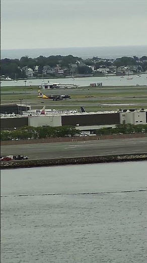 Boat moves through the Boston Harbor with the Logan Airport runways #Shorts