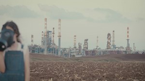 Kids wearing gas masks near an oil refinery - Free Stock Video