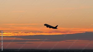 Slow motion shot of passenger airplane taking off and flying on the background of evening sky