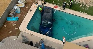 Police: Tesla crashes through brick wall into pool