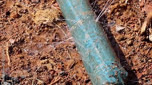 water leaking from hole in a hose, Water pipe break, leaking from hole in a hose connection joint of plastic pipes Water supply system