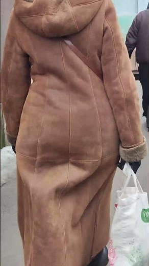 Curvy mature walking in long sheepskin coat