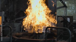 Slow motion of the steel hardening process by heating the metal to critical temperature. Production of metal products. Professional industrial equipment. Manufacturing factory. Heavy industry concept.