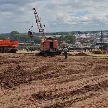 Mining Doc Mining Doc on Instagram: "What Is a Dragline? A dragline is a massive excavating machine mainly utilized in surface mining and civil construction projects. It features a large bucket that hangs from a long boom or mast by cables. The bucket is pulled across the ground to collect material and then lifted by another cable. The machine swings the bucket to where the material is to be dumped and releases it there. Draglines are commonly employed in strip mining to remove layers of soil an
