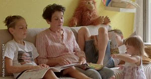 Grandmother spends time with kids, talking to children, gives advices. Role of grandparents in family life. Grandmothers are a source of information, wisdom and comfort. 25.07.2022 Polska, Kladno, CZ