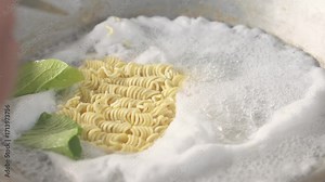 Instant noodles cooked with fresh mustard greens, creating a simple and delicious homemade meal.