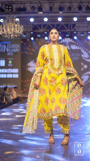 🌟 𝗡𝗲𝘄 𝗔𝗿𝗿𝗶𝘃𝗮𝗹 | 𝗦𝘂𝗻𝗦𝗵𝗶𝗻𝗲 𝗙𝗹𝗼𝗿𝗮𝗹 | 𝗖𝗼𝗹𝗼𝗿𝗹𝗶𝗳𝗲 𝗯𝘆 𝗦𝗵𝗲𝗹𝗮𝗶 🌟 Where golden hues meet timeless grace — a masterpiece that blooms with every step. A celebration of elegance, artistry, and unforgettable fashion moments on the Bangladesh Fashion Runway Week. ✨ #SunShineFloral #ColorlifeByShelai #BangladeshFashionRunway #ShelaiStyle #FashionShow2025 | ColorLife