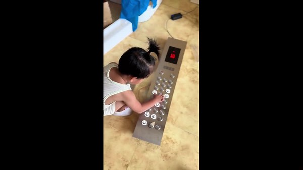 Toddler plays with simulated elevator toy in Liaoning, China