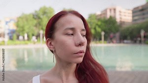 Beautiful Woman with a Band-aid on Her Nose After Rhinoplasty Surgery Posing Looking at the Camera the City Center on a Sunny Day. Concept of Plastic Surgery. Slow Motion.
