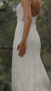 Introducing… Pocahontas from The Disney Fairy Tale Weddings Platinum Collection… New Arrival Style DP425 Embodying Pocahontas's adventurous spirit and deep connection to nature, this elegant sheath gown combines timeless beauty with organic detail. The square neckline and sleeveless design offer a modern, refined silhouette, while the natural waistline is adorned with tonal beading and sequins that add a subtle sparkle. A chiffon leaf pattern is scattered throughout the gown, evoking the natural