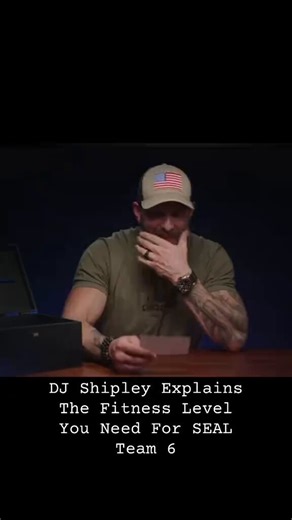 This bearded guy in the American flag hat is sitting at the wooden table holding a little card...He keeps looking down at it then straight at the camera, gesturing with both hands while explaining the exact fitness level you need to make it into SEAL Team 6.Would you try to train to that standard or just admit it’s way out of your league?