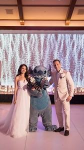When Stitch greets you at your #DisneyWedding reception at Aulani, A Disney Resort & Spa in Hawaii😍🌴 Jessica & Michael shared that “it truly amplified the joy we felt and it felt like we were living in a movie.” 🤍 | Disney's Fairy Tale Weddings & Honeymoons