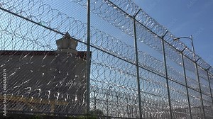 IOWA - 6.28.2024 - Establishing shot of the Iowa State Penitentiary seen through the barbed wire fence. Stock Video