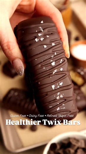 You would not believe this delicious Twix Bars recipe is dairy, gluten, grain, and refined sugar free 🙌🥰 They are easy to make and are a great healthier option for candy season! You can enjoy your favorite treats but don't have to compromise on quality ingredients 😉 Ingredients: • 2 1/2 cups almond flour • 3 tbsp coconut flour • 1/4 cup melted coconut oil(plus 1 tbsp for melting with chocolate chips) • 1/3 cup maple syrup • 2 cups full fat coconut cream(thick part and no liquid) • 1 cup cocon