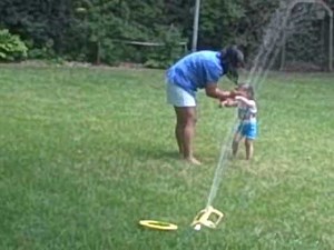 Kids playing in the water sprinkler