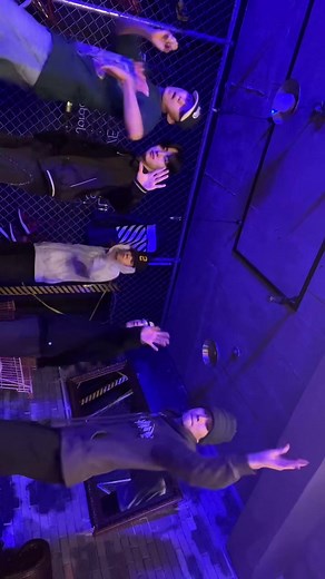 Energetic Dance Moves in a Blue Lit Room