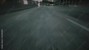 Digital city. Car or motorcycle driving very fast on highway after rain. Close-up cinematic POV shot of wet asphalt in the morning after rain on street