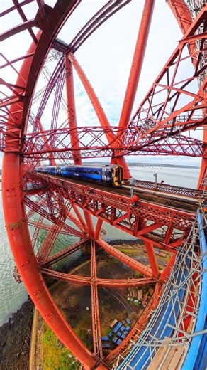Unique perspective - A train passing over the Forth Bridge 💙🏴󠁧󠁢󠁳󠁣󠁴󠁿💛 The Forth Bridges Barnardo's ScotRail #ForthBridge #Scotrail #Scotland #VisitScotland #TheKiltedPhoto #Barnardos | The Kilted Photographer