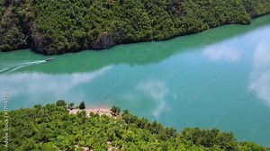 Drone flight above a boat at the lake Koman which is a reservoir on the Drin River in northern Albania.