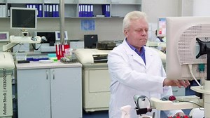 Senior caucasian man controling some process at the laboratory. Aged male scientist working at the science lab. Mature science researcher making calculations