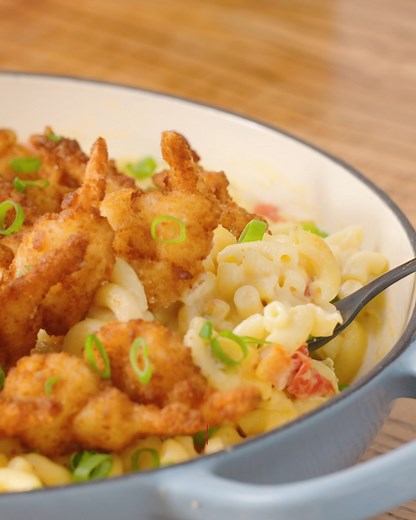 This zesty queso mac and cheese gets the ultimate crunch on top from crispy fried butterfly shrimp! Get the recipe: https://foodtv.com/4bycsjx | Food Network