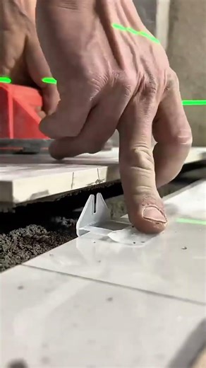 installing white floor tiles with precision tools for professional and high quality construction