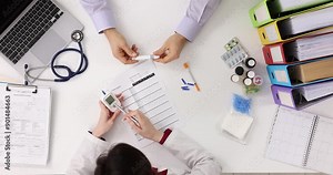 Doctor explains results of blood tests holding glucose meter