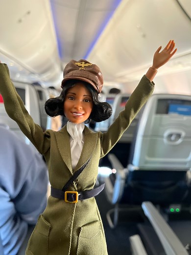 Welcome aboard a birthday flight to honor Bessie Coleman, the first Black and Native American female to earn a pilot's license. American Airlines and Barbie worked together to surprise customers with a Bessie Coleman doll from the Barbie Inspiring Women line. Bessie was a pioneer in aviation and taught us that reaching for the sky is just the beginning. 😊 We were honored to share her inspirational story and celebrate this moment with our customers on Bessie’s birthday. | American Airlines