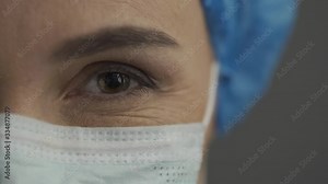 eyes of a smiling nurse or doctor in a surgical mask