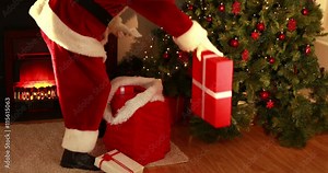 Santa delivering gifts under christmas tree in high quality 4k format Stock Video