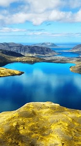 Vertical Screen: Mountain Lake With Clouds Reflection In Water, Iceland Nature. Lava Fields Covered with Yellow Moss in Early Spring. Scenic Epic Aerial View Landscape, Shot for Social Media.