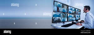 Security System Operator Looking At CCTV Camera Footage On Computer Stock Photo - Alamy