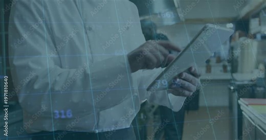 Chef tapping tablet and activating blue data overlay while monitoring orders in commercial kitchen