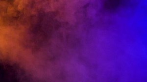 Abstract smoke colorful clouds over a black background in studio