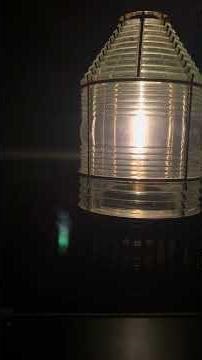calming music by the light of a lighthouse fresnel lens