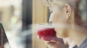 Beautiful woman using ipad touchscreen tablet display in cafe