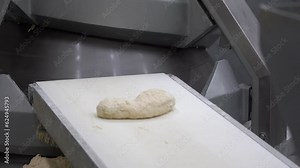 Fresh Bread Dough on Industrial Bakery Line. Dough Moving Along Conveyor Belt at Bread Factory. Industrial Bakery Equipment. Industrial Bakery Production Line.