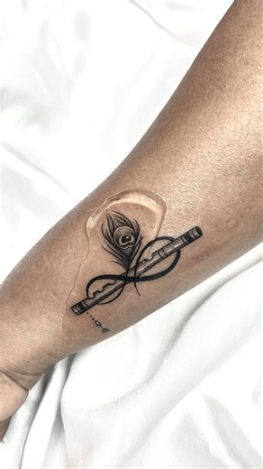 INK VALLEY TATTOO on Instagram: "1. Flute (Bansuri) – The flute is often associated with Lord Krishna, symbolizing divine love, harmony, and the music of life. It represents the soul’s connection to the divine and the beauty found in simplicity. 2. Peacock Feather – Also linked to Krishna, the peacock feather symbolizes purity, beauty, compassion, and protection. It’s believed to ward off negativity and bring peace and positivity. 3. Infinity Symbol – The infinity loop represents eternity, limit