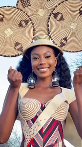 National Costume Reveal 2.0 The national costume dress, inspired by the traditional attire of people of northern Namibia, is a vibrant and culturally rich garment that reflects both historical significance and modern aesthetics. Design and Materials: The dress is crafted from Odelela fabric, characterized by its striking red, blue, and pink stripes. This material has transcended its regional roots to become popular across various cultures within the country displaying versatility amongst Namibia