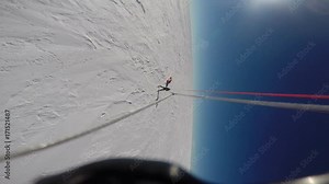 A gopro shot from a parasail. The shot was going in a round motion as the parasail flies in the sky.