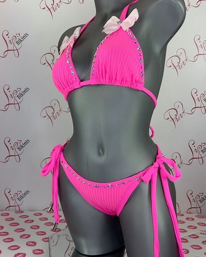 Get ready to shine in this neon pink two-piece bikini! Adorned with neon pink bows and covered in Swarovski crystals, the textured straight fabric adds a playful touch. Perfect for making a fun and flirty statement at the beach or poolside! More Exciting designs available on our website www.pinklipsbikini.com 👙💕 Click the Link on my Bio Hand-Made in Canada 🍁 WE SHIP WORLDWIDE 📦 🚚 #PinkLipsBikini #BikiniLife #BikiniGoals #BeachBabe #PoolsidePerfection #SunKissed #SummerVibes #BeachReady #Swi
