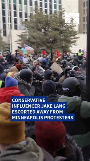 Conservative influencer Jake Lang was met with heavy pushback from protesters in Minneapolis on Saturday as tensions continue to run high in the city. The clash comes amid ongoing demonstrations over a major federal immigration enforcement operation and the controversial killing of Renee Good by an ICE agent, which has sparked daily protests and widespread criticism of the federal response. Watch to see how the crowd overwhelmed Lang and hear from people on the streets. | Scripps News