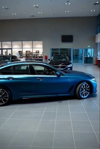 "The Stunning Blue BMW in the Showroom: A Closer Look at Luxury!"