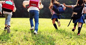 clip-1062426421-rear-view-elementary-school-kids-running-on
