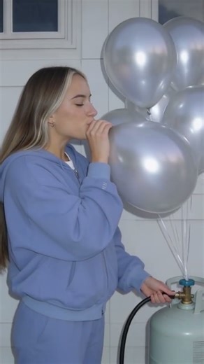 Cutie blowing up balloons