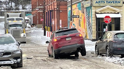Vehicle gets stuck in sinkhole caused by water main break in Pittsburgh’s Strip District