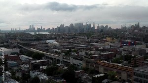 aerial flying over Brooklyn subway entering aboveground tunnel Manhattan skyline NYC